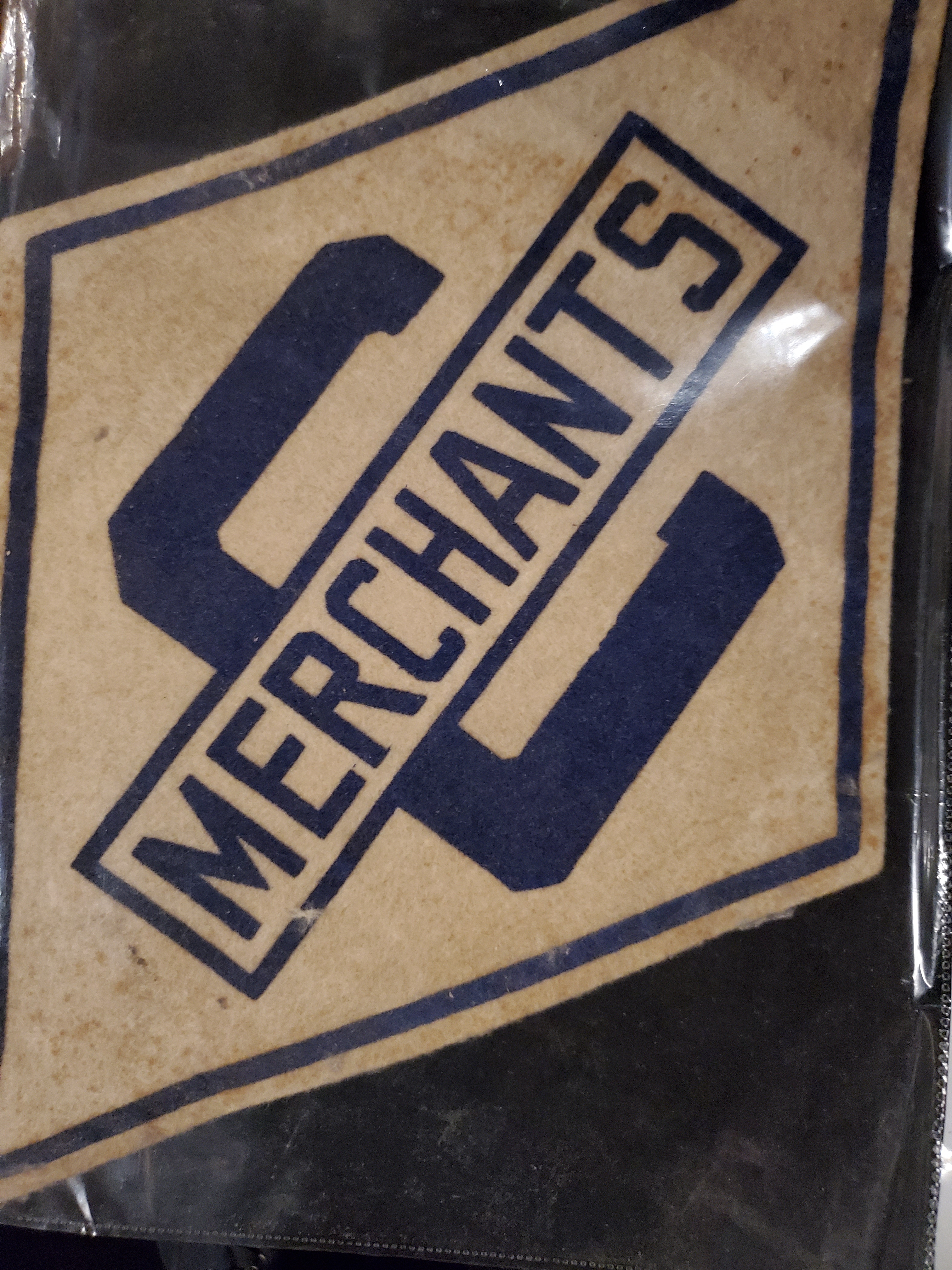Neil Cane Cobourg Merchants crest 'C Merchants'