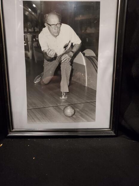 Male bowler delivering 5 pin ball down alley