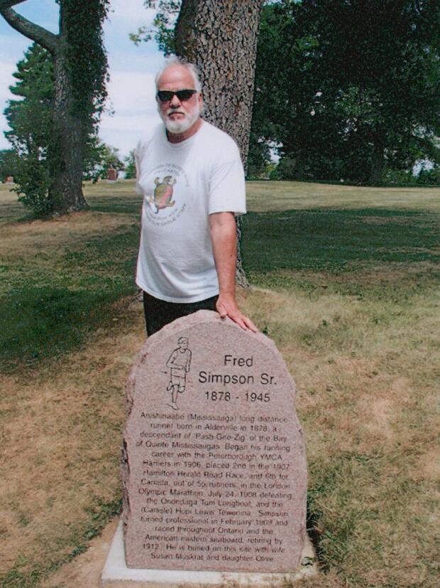 2020 Fred Simpson 1878-1945 gravestone photo at Alderville- grandson Dave Mowat standing
